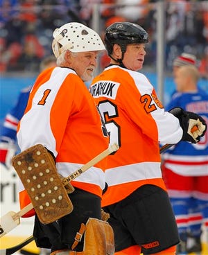 Bernie Parent, left, and Orest Kindrachuk, of the Philadelphia
Flyers alumni team, stand on the ice during warmups before an
exhibition NHL hockey game with the New York Rangers alumni team on
Saturday, Dec. 31, 2011, in Philadelphia. The Flyers won 3-1. (AP
Photo/Tom Mihalek)