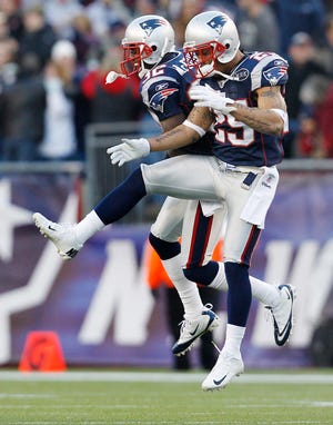 New England Patriots cornerback Devin McCourty (left) celebrates his interception with free safety Patrick Chung during the fourth quarter of New England's 49-21 win over the Bills.
