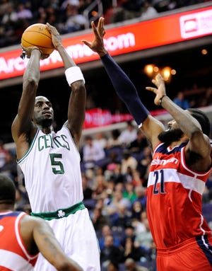 Celtics forward Kevin Garnett (5) shoots against Washington Wizards center Ronny Turiaf during the first half of Boston's New Year's Day win over Washington.