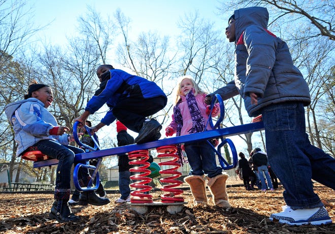 Sofia Daniels, from left, Devon Charlton, Olivia Collins and Rodney Deadwyler brave the cold during recess at Chase Street Elementary School on Tuesday, Jan. 3, 2012 in Athens, Ga.