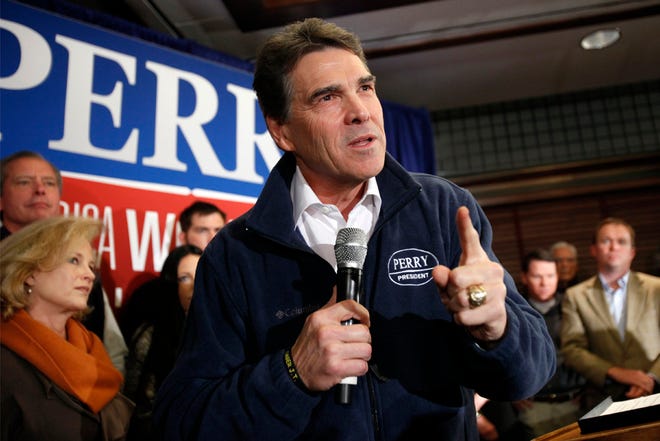 Gov. Rick Perry speaks to local residents Monday during a campaign stop at Hotel Pattee in Perry, Iowa.