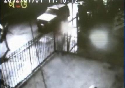 In this frame grab taken from surveillance video released by the NYPD, a suspect, left, throws a lit object at a home in the Queens borough of New York on Sunday night, Jan. 1, 2012. This attack and three others in the neighborhood, including one on a globally prominent Islamic cultural center, are being investigated as possibly linked bias crimes.
