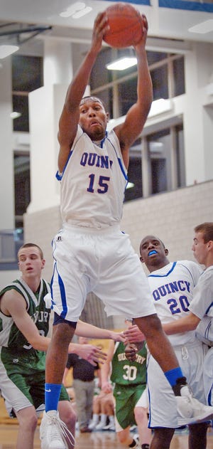 Quincy's Zerick Fadairo pulls down a defensive rebound during the Presidents' 50-48 victory on Friday night.