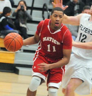 Natick's Deonte Flounory drives the baseline during the Red and Blue's 43-39 win over Framingham.