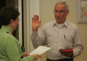 Photo by Amy Herzog/New Jersey Herald Gregory Corcoran is sworn in for a new three-year term on Lafayette Township Committee and was also sworn in as mayor by Anna-Rose Fedish Tuesday.
