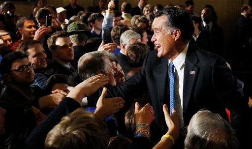 Republican presidential candidate former Massachusetts Gov. Mitt Romney, greets supporters his caucus night rally in Des Moines, Iowa, Tuesday, Jan. 3, 2012.