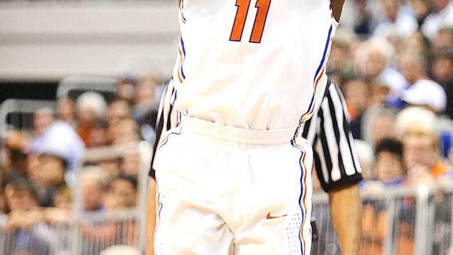 Florida's Erving Walker (11) shoots for three points during the first half of an NCAA college basketball game against UAB in Gainesville, Fla., Tuesday, Jan. 3, 2012.