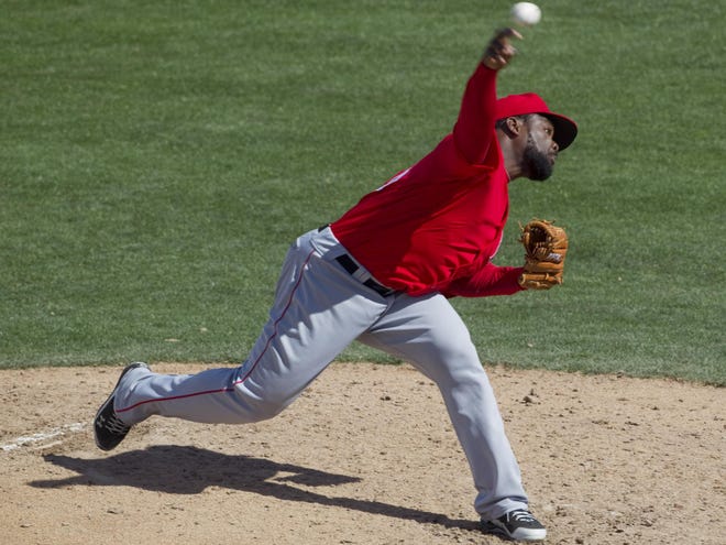In this March 7, 2011, file photo, Los Angeles Angels pitcher Fernando Rodney delivers against the Chicago Cubs during the fourth inning of a spring training baseball game in Mesa, Ariz. Rodney has agreed to a one-year contract with the Tampa Bay Rays. The deal is worth $2 million and includes a club option for 2013.