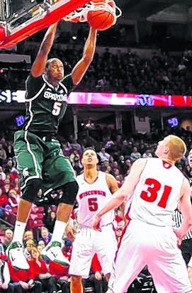 Michigan State's Adreian Payne (5) dunks over Wisconsin's Ryan Evans (5) and 
Mike Bruesewitz (31) on Tuesday in Madison, Wis.
ASSOCIATED PRESS / ANDY MANIS