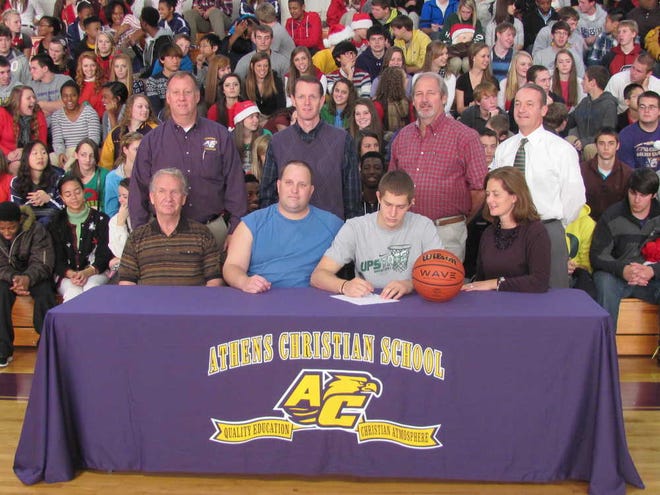 Seated on the first row is Zach Lillie's grandfather, Roy Lillie, his father, Stephen Lillie, Zach, and his mother, Karen Lillie. Back row is Athletic Director Van Beacham, Principal Dr. Bruce Hockema, Asst. Coach Tim Cummings, and Headmaster Steve Cummings.