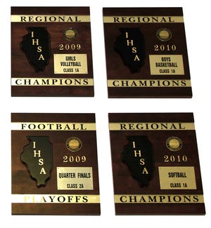 A few of the regional championship plaques displayed over the entrance to the Orion High School gymnasium.