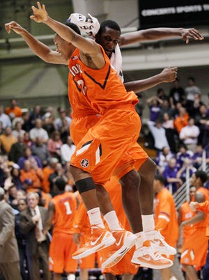 Nanna Egwu (32) of Illinois celebrates with Joseph Bertrand after Illinois defeated Northwestern 57-56 in a Big Ten Conference game in Evanston on Wednesday.