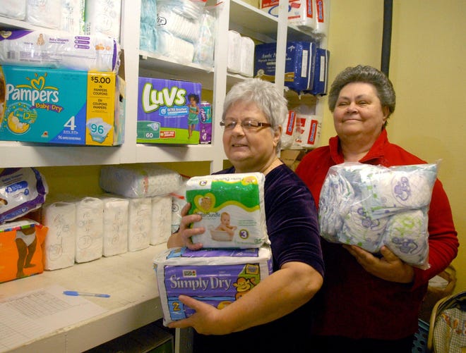 Diaper Bank coordinator Helen Ferland, left, and Kathi Peterson, volunteer director at the Daily Bread Food Pantry, show some of the diapers at the pantry, which is located at the United Methodist Church in Putnam.