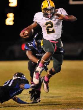 Yulee running back Derrick Henry (2) runs away from First Coast defenders during a game last season.