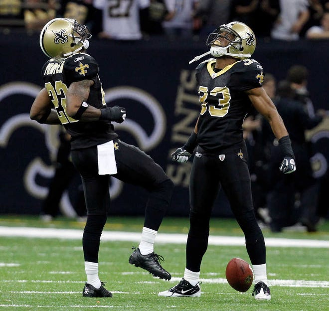 New Orleans Saints cornerback Jabari Greer (33) celebrates with teammate Tracy Porter after Greer intercepted a pass Saturday during the second half against the Detroit Lions.
