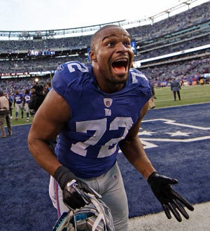 New York Giants defensive end Osi Umenyiora celebrates Sunday after defeating the Atlanta Falcons a wild card playoff game.