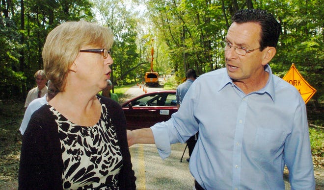 Gov. Dannel P. Malloy talks to Cathy Osten, Sprague first selectman, while touring storm damage Wednesday on Saltrock Road in Hanover.