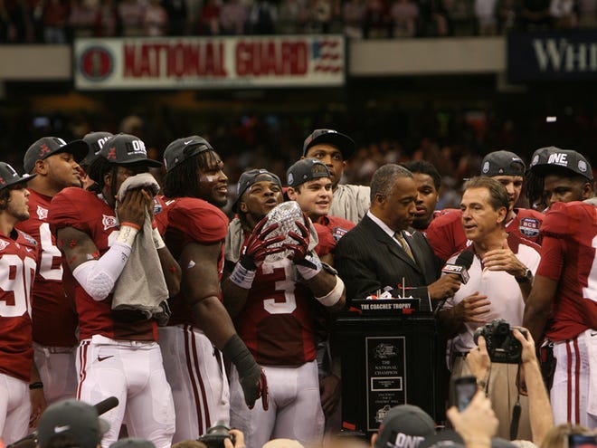 The Alabama football team celebrates on stage after winning the BCS National Championship Game against LSU in New Orleans Monday.