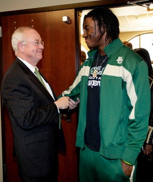 Baylor President Ken Starr, left, talks with Robert Griffin III on Wednesday after the quarterback announced he was going pro.