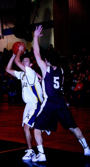 Zach Faulkner looks to the basket during the Blue Devils’ home game against Big Spring Friday.