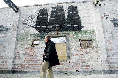 Photo by Amy Herzog/New Jersey Herald - Tim Rider, a spokesperson for Picatinny Arsenal, shows several paintings uncovered in a building undergoing construction for an education center. The murals date back to World War II.
