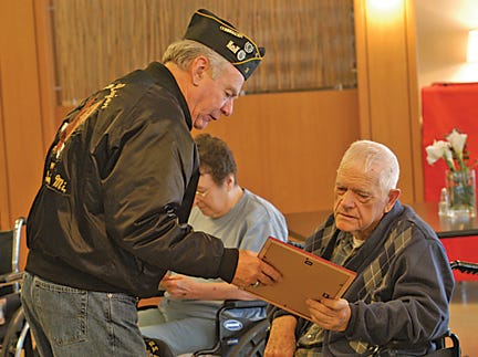 Dan Inglis of American Legion Post #3 presented Roy Smith of Kincheloe with a certificate and new hat honoring his service with the U.S. Armed Forces. Smith was one of about a half-dozen residents honored at Tendercare on Tuesday.
