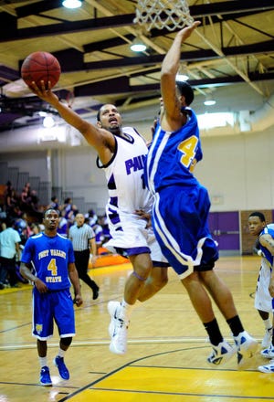 Paine's Autis Gibson tries to get around Fort Valley State's Nigel Domineck's block attempt. The Lions lost in overtime after committing 35 turnovers.