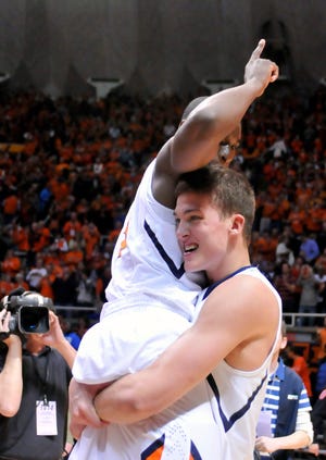 Illinois' Meyers Leonard (12) lifts teammate Brandon Paul (3) as they celebrate the team's 79-74 win over Ohio State in an NCAA college basketball game in Champaign, Ill., on Tuesday, Jan. 10, 2012.