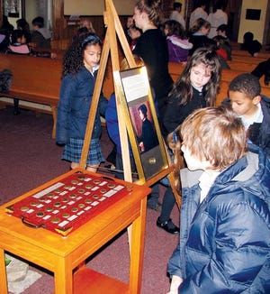 Submitted Photo - Children at St. Michael’s Elementary School in Netcong peruse the St. Elizabeth Ann Seton relic and ancient coin collection donated by Sparta resident Angelo Diaz.
