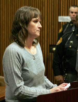 In this March 26, 2009 file photo, Monica Hussing., is seen in court in Cleveland, Ohio as she was indicted along with her husband William Robinson Sr. for involuntary manslaughter, child endangering and felonious assault in the death of their son William Robinson Jr. Both parents pleaded guilty Monday to attempted involuntary manslaughter in a last-minute plea deal before the start of their trial in the death of their son who died from Hodgkin's lymphoma after suffering for months from undiagnosed swollen glands. (AP Photo/MBR/Chuck Crow/Cleveland Plain Dealer)
