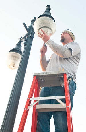 Barry Shearer of Shearer Electric replaces streetlamp bulbs with new LED lights that will save on energy and last much longer than the less-modern counterparts.