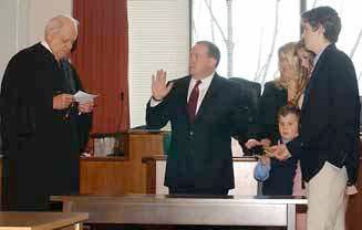 Judge Henry Scudder swears in Brooks Baker as the new Steuben County District Attorney Friday morning in Bath as Baker’s family looks on.