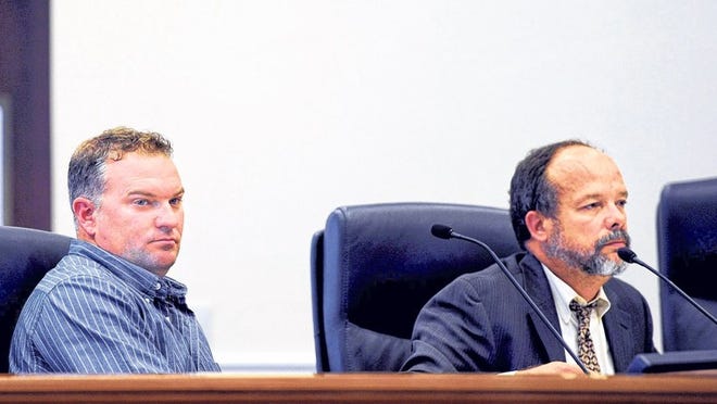 Former Fire-Rescue Battalion Chief Jason Weeks and his attorney, Isidro Garcia, listen to Human Resources Director Danielle Olson testify during a hearing in front of the Town Council’s Administrative and Personnel Committee.