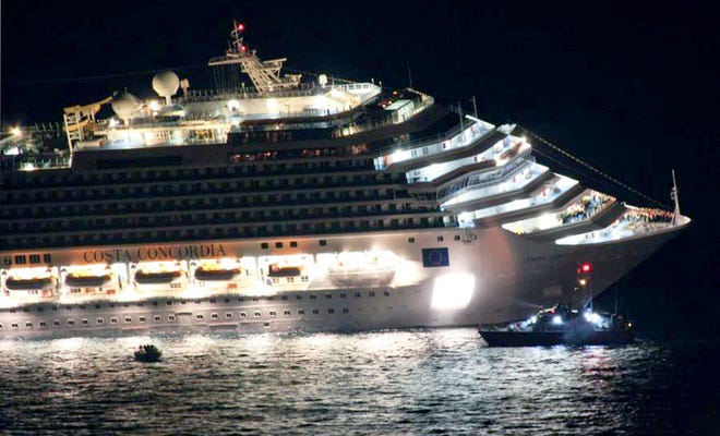 Rescuers surround the luxury cruise ship Costa Concordia after it ran aground off the coast of Isola del Giglio island, Italy, gashing open the hull and forcing some 4,200 people aboard to evacuate aboard lifeboats to the nearby Isola del Giglio island, early Saturday, Jan. 14, 2012. About 1,000 Italian passengers were onboard, as well as more than 500 Germans, about 160 French and about 1,000 crew members. (AP Photo/Giglionews.it, Giorgio Fanciulli)