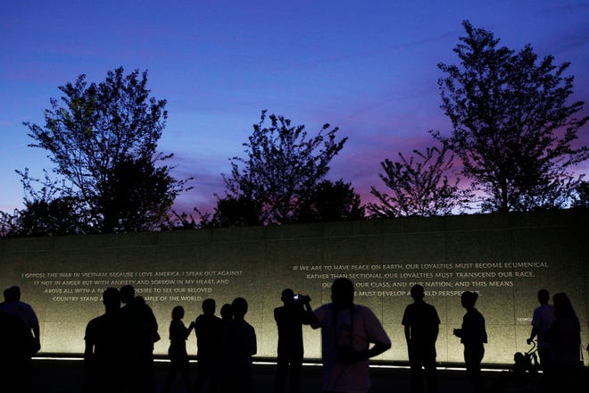 In this Monday, Aug. 22, 2011, photo, quotes by Martin Luther King, Jr., are inscribed in the wall at the Martin Luther King, Jr. Memorial as it is seen at dusk ahead of its dedication this weekend in Washington. A quote carved in stone on the new Martin Luther King memorial in Washington will be changed after the inscription was criticized for not accurately reflecting the civil rights leader's words. (AP Photo/Charles Dharapak)