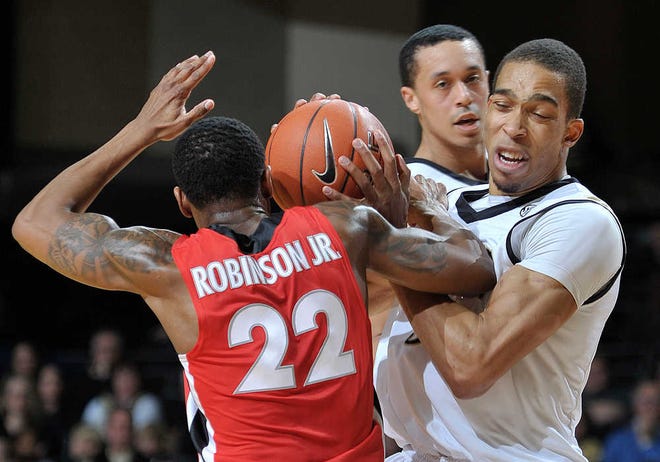 Georgia guard Gerald Robinson, right, fights for the ball with Vanderbilt forward Lance Goulbourne in the first half of an NCAA college basketball game on Saturday, Jan. 14, 2012, in Nashville, Tenn. (AP Photo/Joe Howell)
