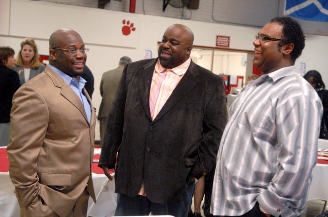 The Rev. Devin Johnson, left, talks with Rasheem Santiago and Byron Johnson before the annual holiday luncheon Friday at Norwich Free Academy. The Rev. Johnson received the Robertsine Duncan Award for youth services.