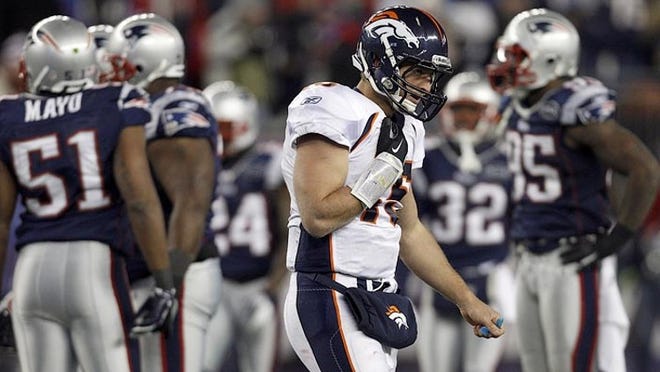 Denver Broncos quarterback and former Gators star Tim Tebow (15) walks off the field during the second half of a 45-10 AFC divisional loss to the Patriots on Saturday, Jan. 14, 2012.