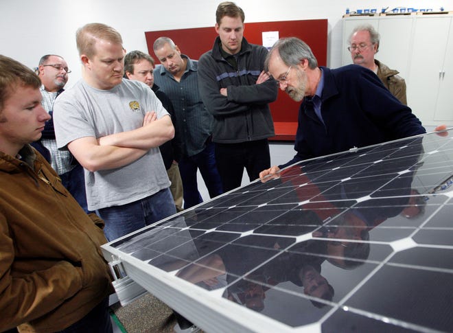 Bob Croteau discusses the technology inside a solar electric panel during Introduction to Renewable Energies Jan. 12 at Lincoln Land Community College. The class covers alternative energies ranging from biofuels and wind energy to passive solar and solar electric technology.