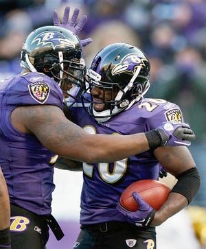 Ravens free safety Ed Reed, right, celebrates his interception with outside linebacker Terrell Suggs during the second half of the Ravens' victory over the Texans on Sunday in Baltimore.