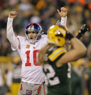 AP Photo/Darron Cumming - Giants quarterback Eli Manning reacts in front of Packers linebacker Clay Matthews, right, after throwing a 37-yard touchdown pass to Hakeem Nicks during the first the first half of an NFL divisional playoff football game.