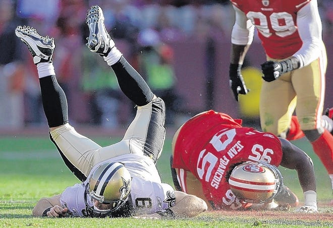Saints quarterback Drew Brees (9) is sacked by 49ers defensive tackle Ricky Jean-Francois on Saturday.