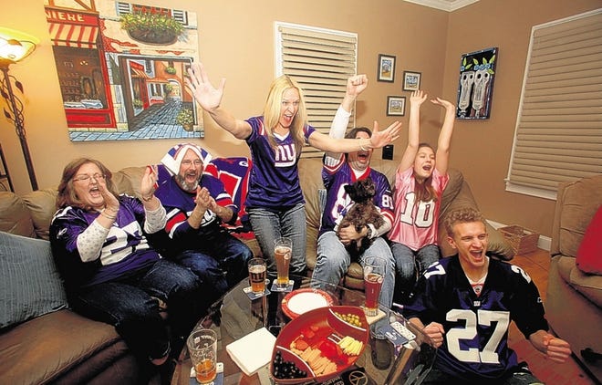 Giants fans across the region gathered Sunday for the big game. Rachel Taylor, center; her husband, Chris, fourth from left; daughter Sydney; and son Andrew celebrate during the game. Their friends, Jean and Steve Gastman, at left, join in the fun. The Giants advanced to the NFC Championship game next Sunday.