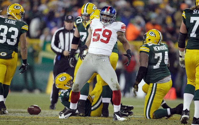 Giants linebacker Michael Boley (59) reacts after sacking Packers quarterback Aaron Rodgers during the second half Sunday, January 15, 2012.