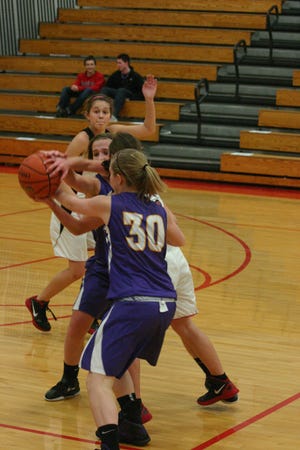 Canton's Natalie Martindale and Megan Putrich sandwiched themselves around a Metamora player and the ball in Mid-Illini Conference action Tuesday night. Coach Layne Langholf's team got off to bad start and went on to lose 63-39.