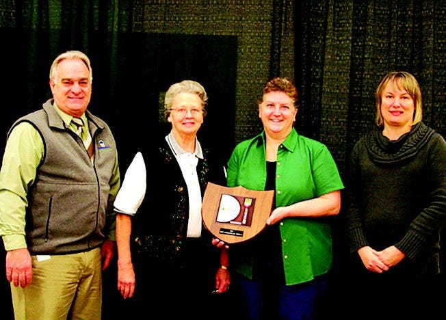 Vernice and Kim Eshleman (center) of Mrs. Gibble’s Restaurant were honored at a special breakfast Wednesday at the PA Farm Show in Harrisburg as winners of the 2012 Best Marketplace Award for their display. Presenting the award were PA Agriculture Secretary George Greig (left) and Farm Show representative Deb Trump.
