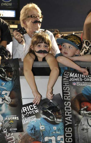 Photos by Will.Dickey@jacksonville.com Jaguars fans Barbara Rock (top) with grandchildren Jillian Rock, 8 and Sam Rock, 6, wait for autographs at the Ready to Rise rally Tuesday night at EverBank Field in Jacksonville. For a photo gallery from the event, go to Jacksonville.com.
