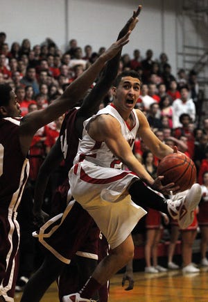 Milford's Michael Titlebaum goes to the basket against Fitchburg's Charles Doss last night.