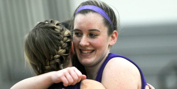 East Stroudsburg South's Tara Steakin gets a hug from teammate Brittany Poje (24) after Steakin scored her 1,000th point during their game against East Stroudsburg North on Tuesday night, January 17, 2012.