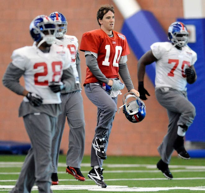 New York Giants quarterback Eli Manning loosens up during an NFL football practice Thursday, Jan. 19, 2012, in East Rutherford, N.J. The Giants travel to San Francisco to play the 49ers in the NFC championship game on Sunday, Jan. 22. (AP Photo/Bill Kostroun)